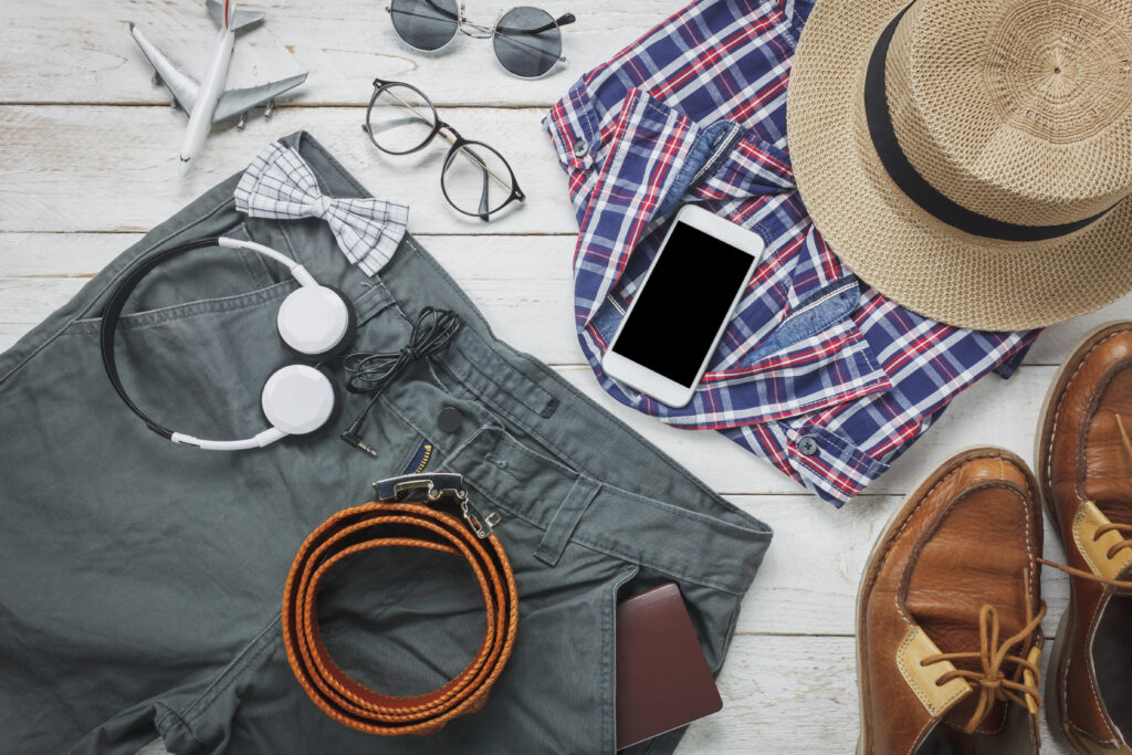 Top view accessoires to travel with man clothing concept. shirt,